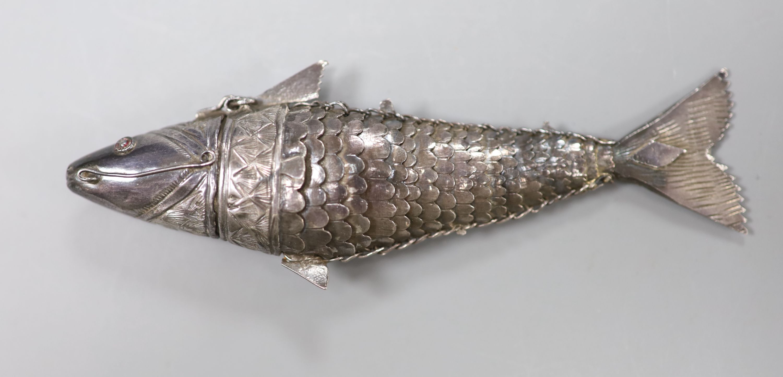 A continental white metal articulated fish pill box, with hinged head